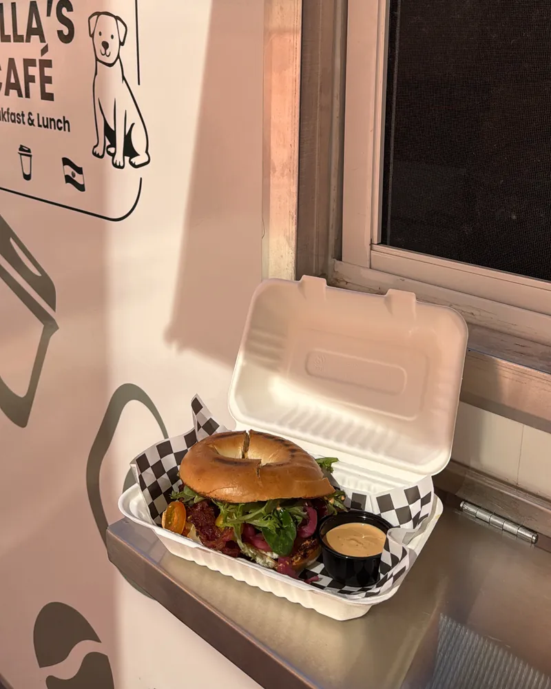 Breakfast sandwich on a toasted bagel in a takeout box