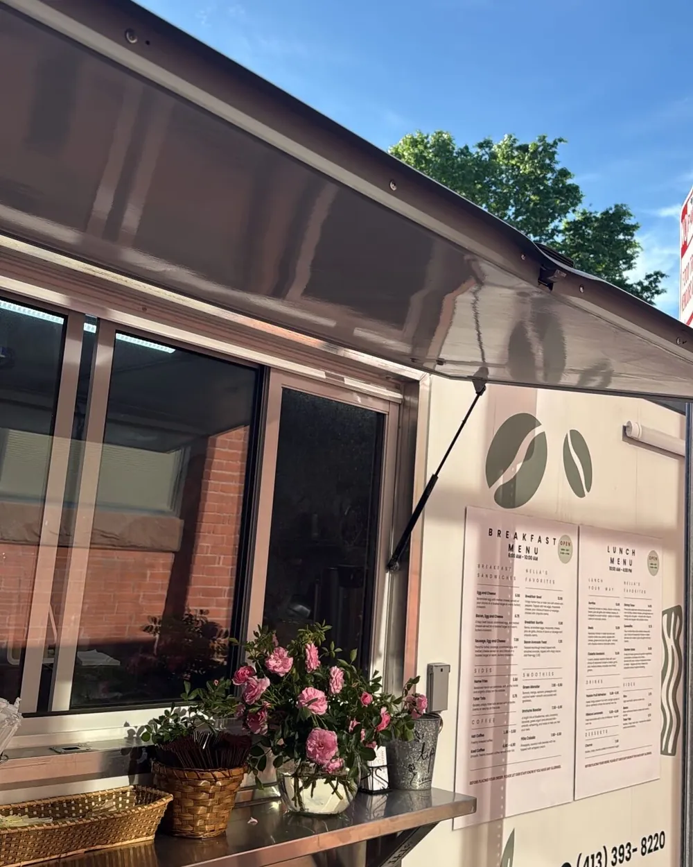 The Nella's Café trailer on Birnie Ave, service window open